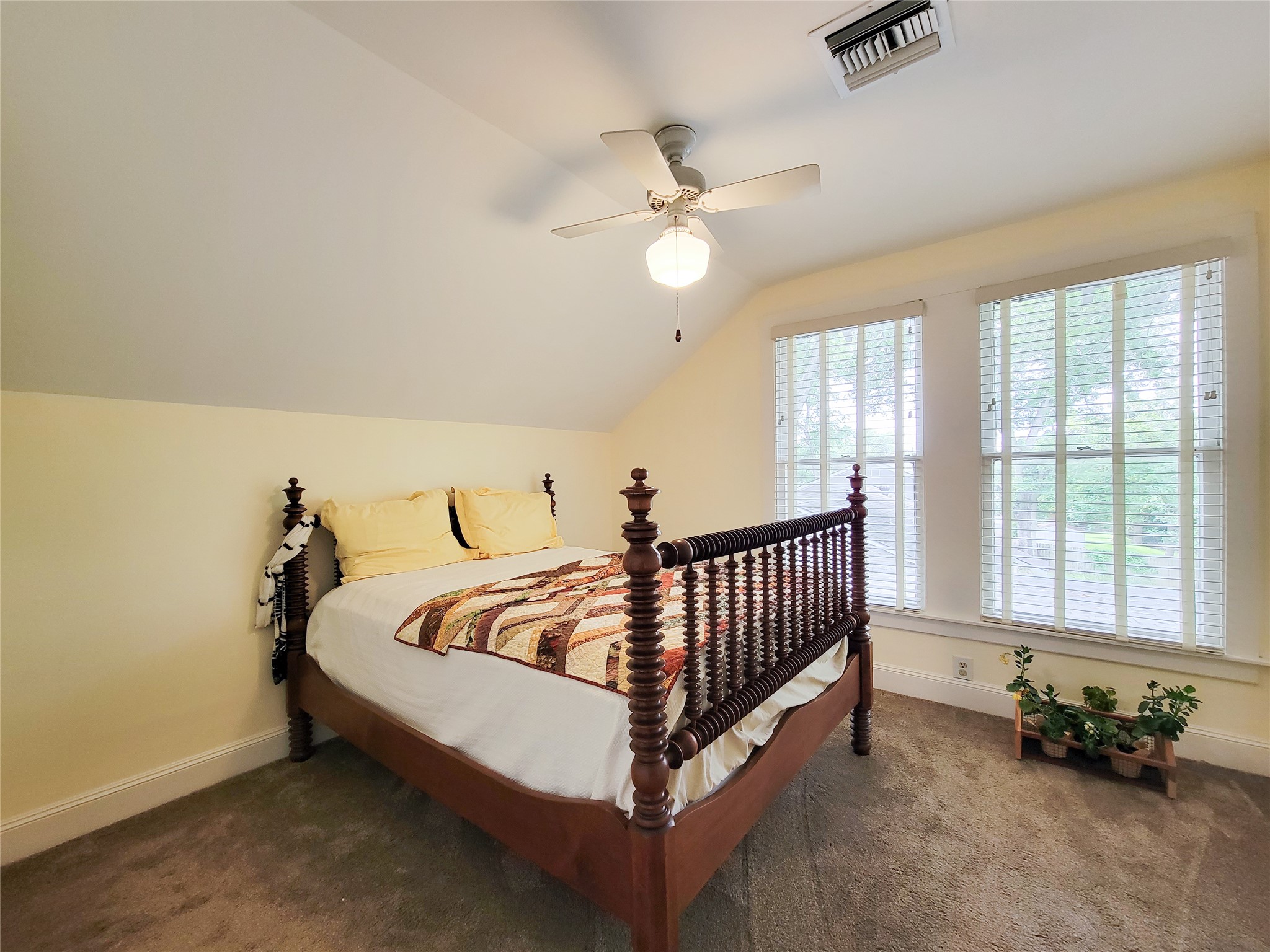 1406 Key Street Brenham, TX 77833 - Photo 24 of 50 Enjoy stunning views of the lush outdoor grounds from this upstairs bedroom, featuring expansive windows.