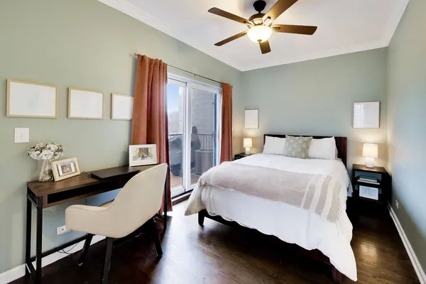 a bedroom with a large bed and a chandelier