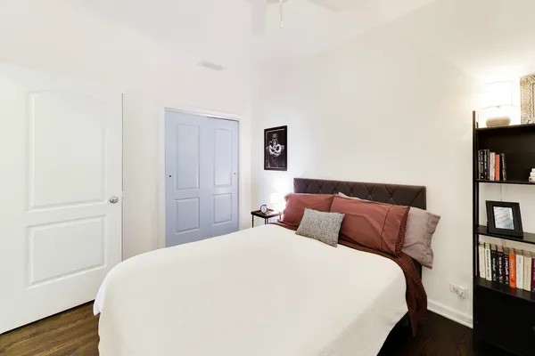 a bedroom with a bed and a book shelf
