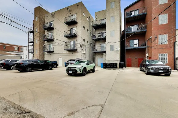 a city street lined with cars parked in front of buildings