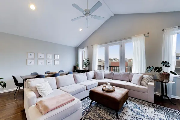a living room with furniture and wooden floor