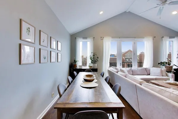 a living room with fireplace a dining table and a fireplace