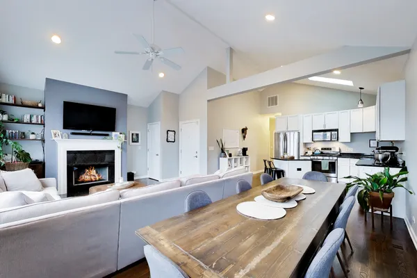 a kitchen with stainless steel appliances a microwave a stove a sink a refrigerator and white cabinets