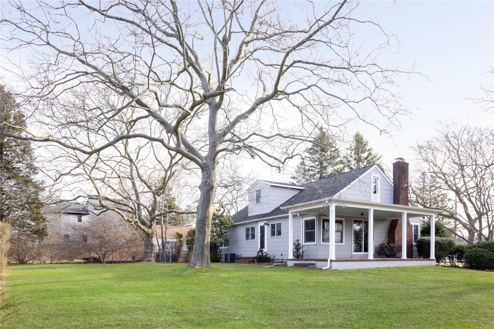 565 Cedar Drive Southold, NY 11971 - Photo 1 of 1 front view of the house with a yard