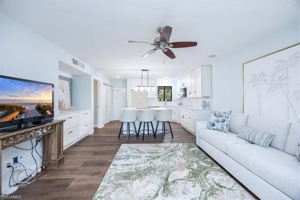 a living room with furniture and a wooden floor