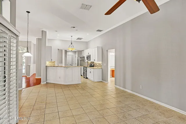 a view of a kitchen with furniture and refrigerator