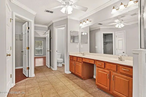 a spacious bathroom with a granite countertop sink mirror and a shower