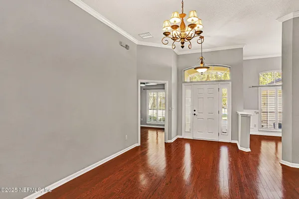 a view of an entryway with wooden floor