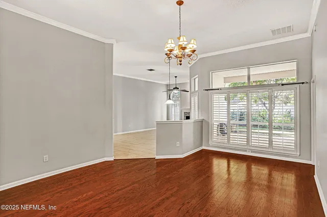 a view of a room with wooden floor and a window
