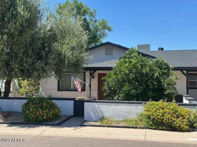 a view of a house with a yard and plants