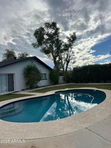a view of a swimming pool with a yard