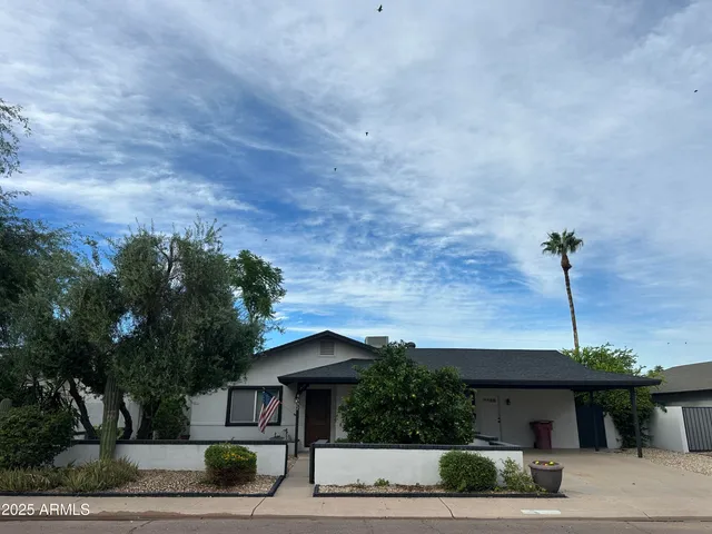 a front view of a house with a garden