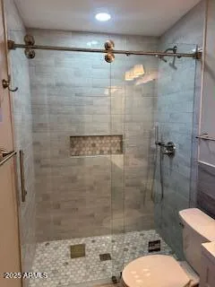 a bathroom with a toilet and shower