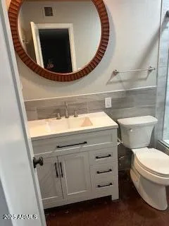 a bathroom with a toilet a sink and mirror