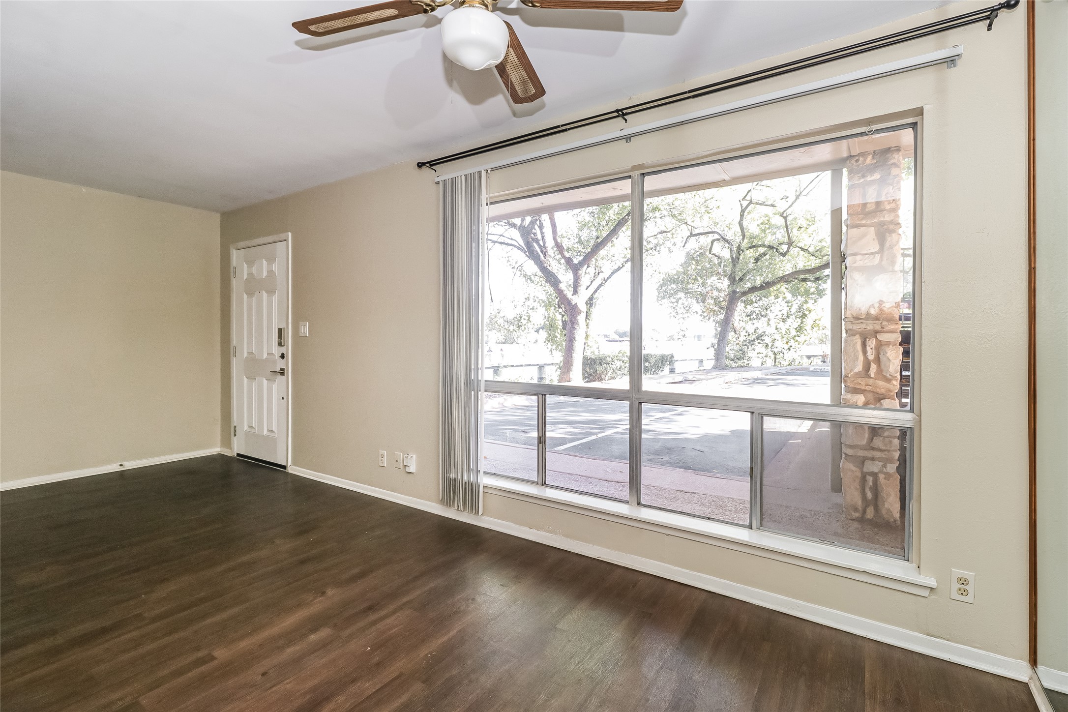 500 East Riverside Drive, Unit 135 Austin, TX 78704 - Photo 6 of 16 Empty room featuring dark wood finished floors and a ceiling fan