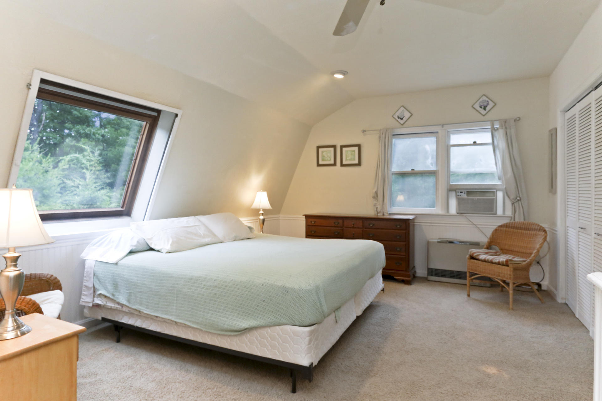 645 Scraggy Neck Road Cataumet, MA 02534 - Photo 21 of 32 a bedroom with a bed chair and a window