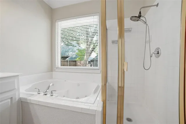 a bathroom with a tub and a window