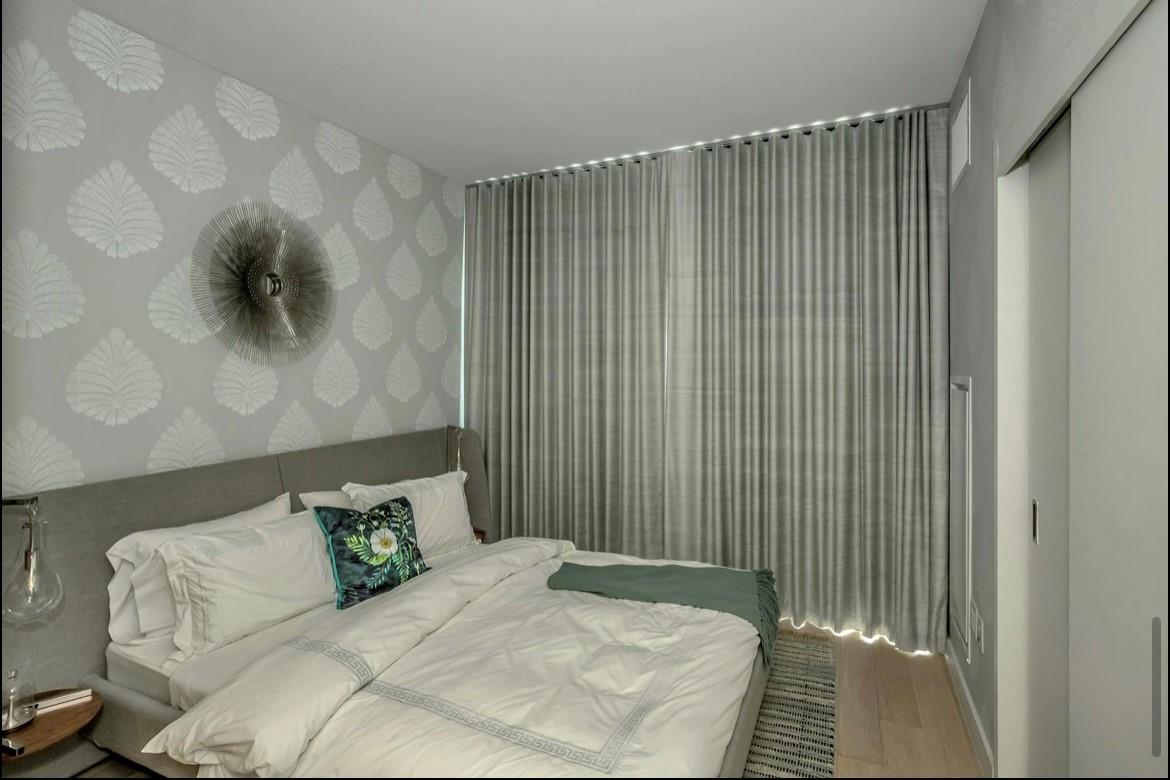 131-01 40 Road, Unit 11N Queens, NY 11354 - Photo 15 of 18 Bedroom with wallpapered walls and wood finished floors