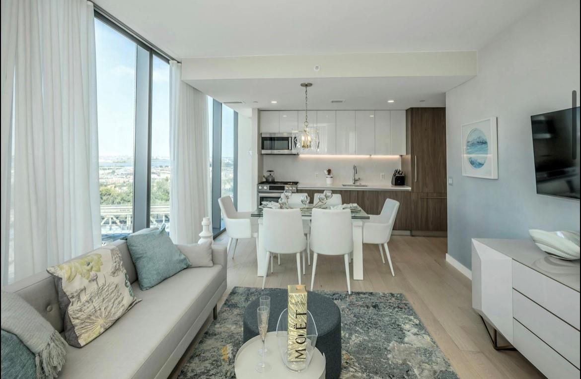 131-01 40 Road, Unit 11N Queens, NY 11354 - Photo 4 of 18 Living area with healthy amount of natural light, light wood finished floors, and floor to ceiling windows