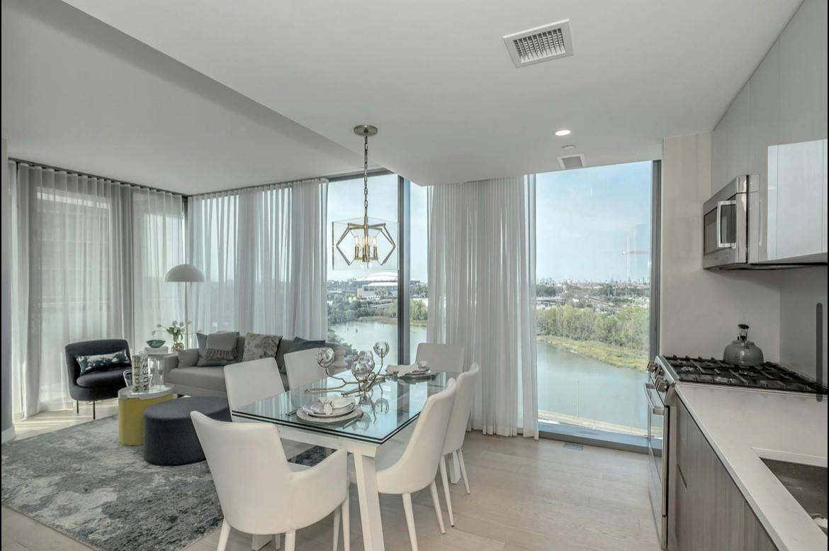 131-01 40 Road, Unit 11N Queens, NY 11354 - Photo 9 of 18 Dining area featuring a chandelier, a water view, floor to ceiling windows, and light wood-type flooring