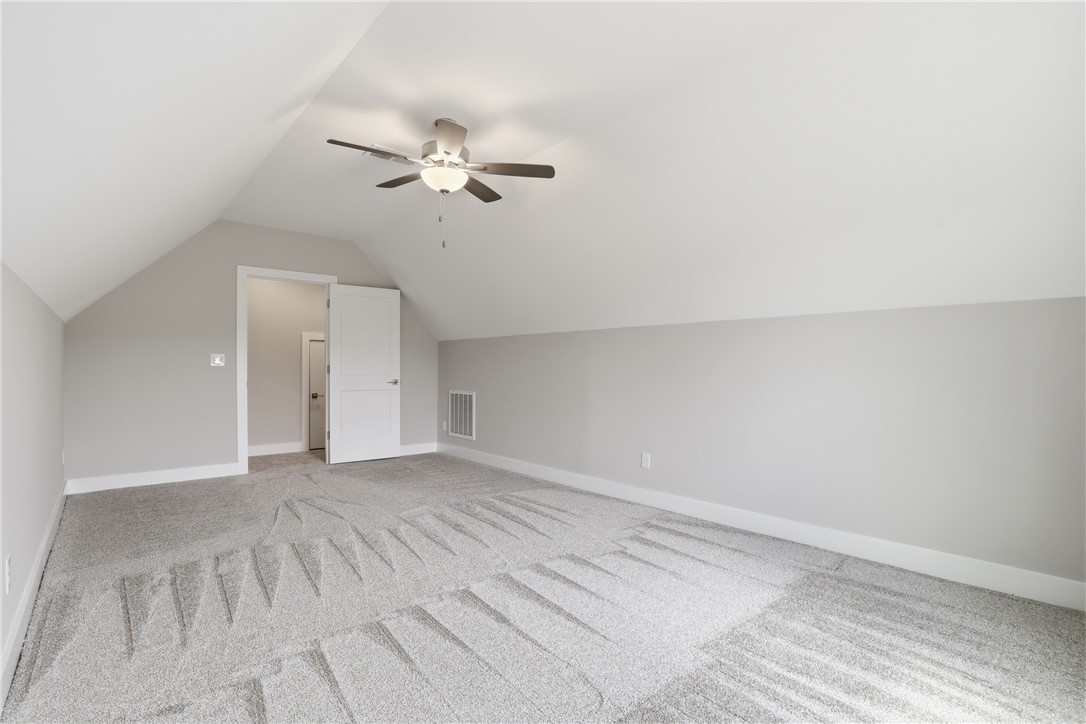 736 Stewart Gin Road Liberty, SC 29657 - Photo 37 of 50 This versatile bonus room offers ample space, a vaulted ceiling, and carpeted flooring for comfort.