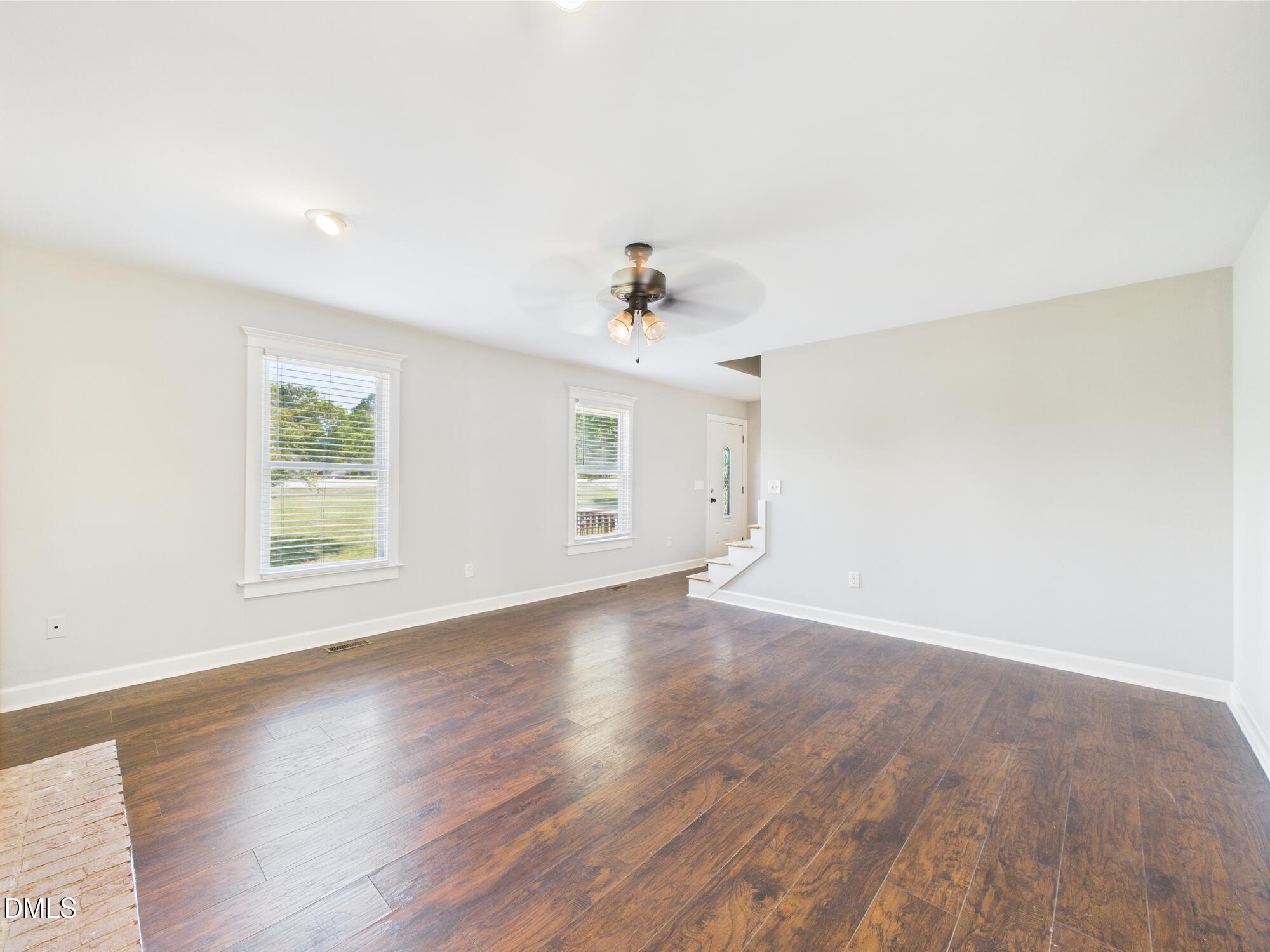 10917 Fanny Brown Road Raleigh, NC 27603 - Photo 15 of 54 an empty room with wooden floor and windows
