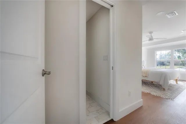 a bedroom with a bed mirror and wall painting