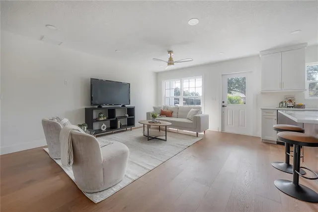 a living room with furniture and a piano