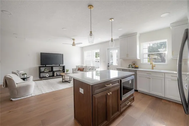 a kitchen with granite countertop a sink counter top space appliances and cabinets