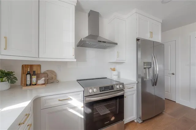 a kitchen with stainless steel appliances granite countertop a stove and a refrigerator