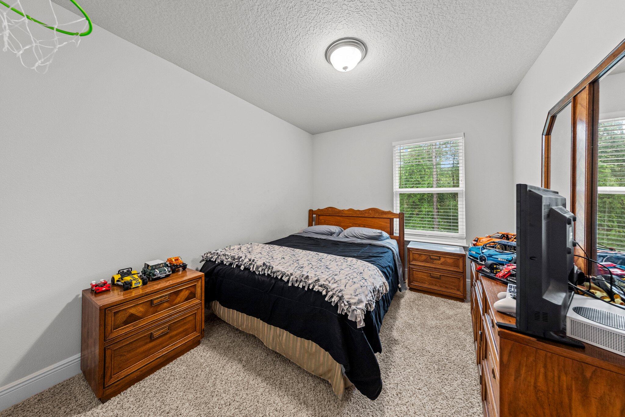 8 Sandy Cv Way Miramar Beach, FL 32550 - Photo 22 of 50 a bedroom with a bed and a flat tv screen on the dresser