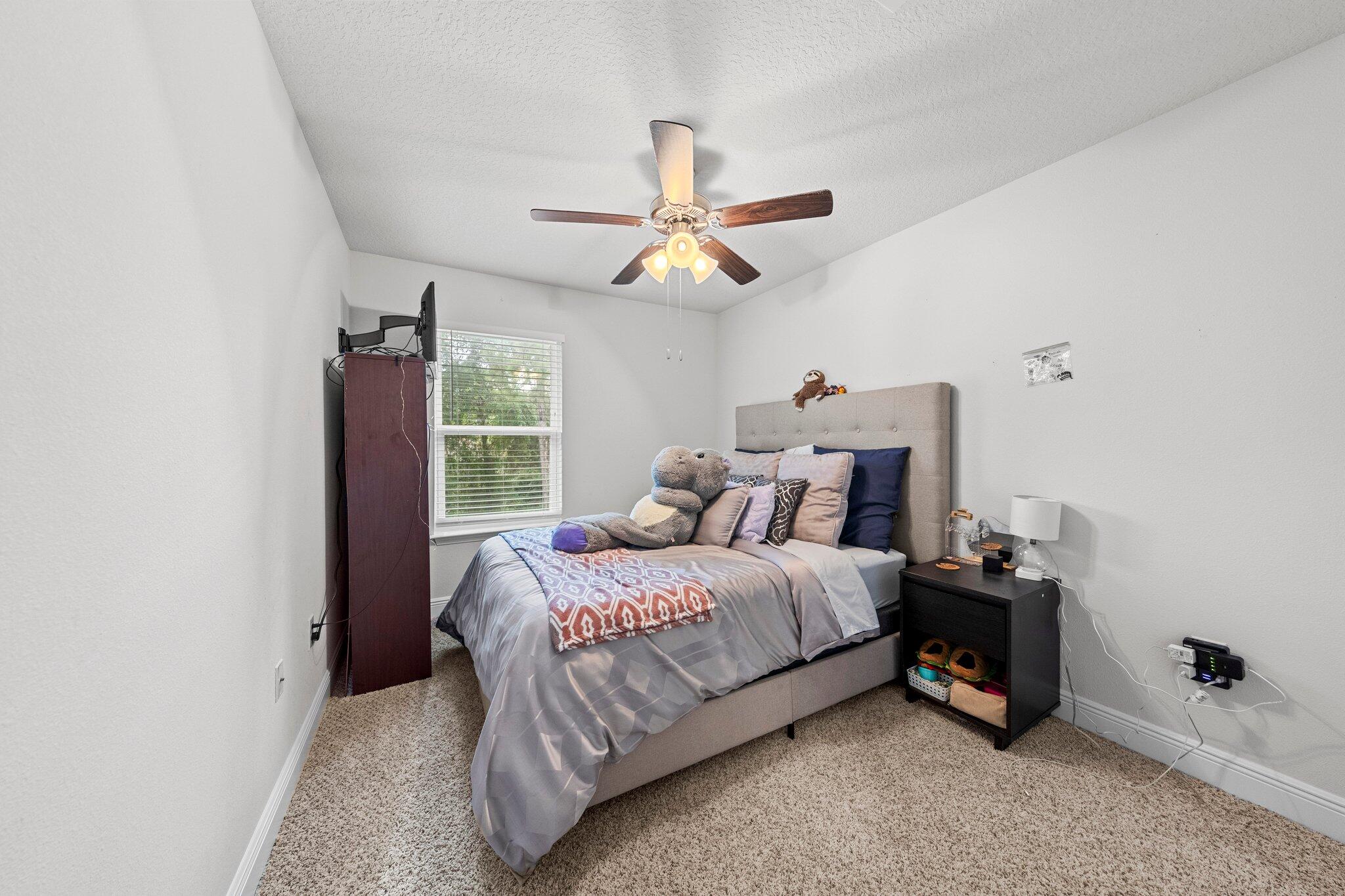 8 Sandy Cv Way Miramar Beach, FL 32550 - Photo 26 of 50 a bedroom with a bed a chandelier and a window