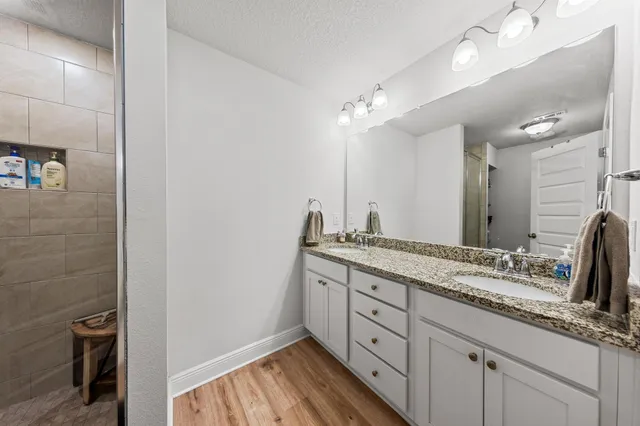 a bathroom with a double vanity sink and a mirror
