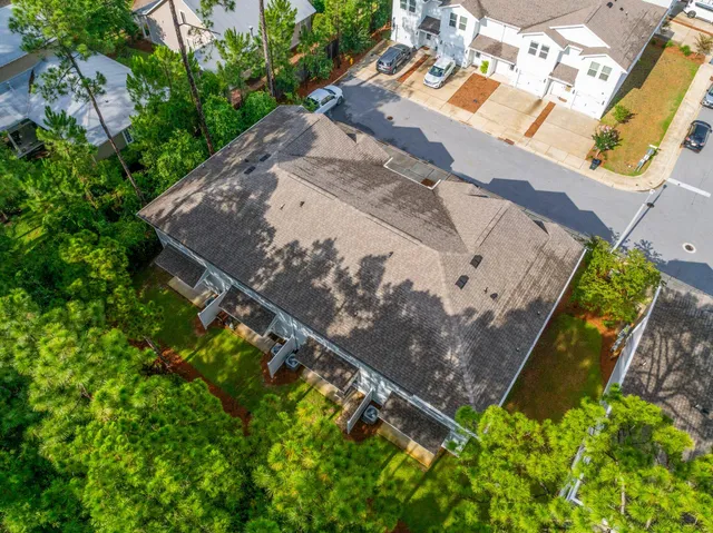 an aerial view of residential houses with outdoor space and swimming pool