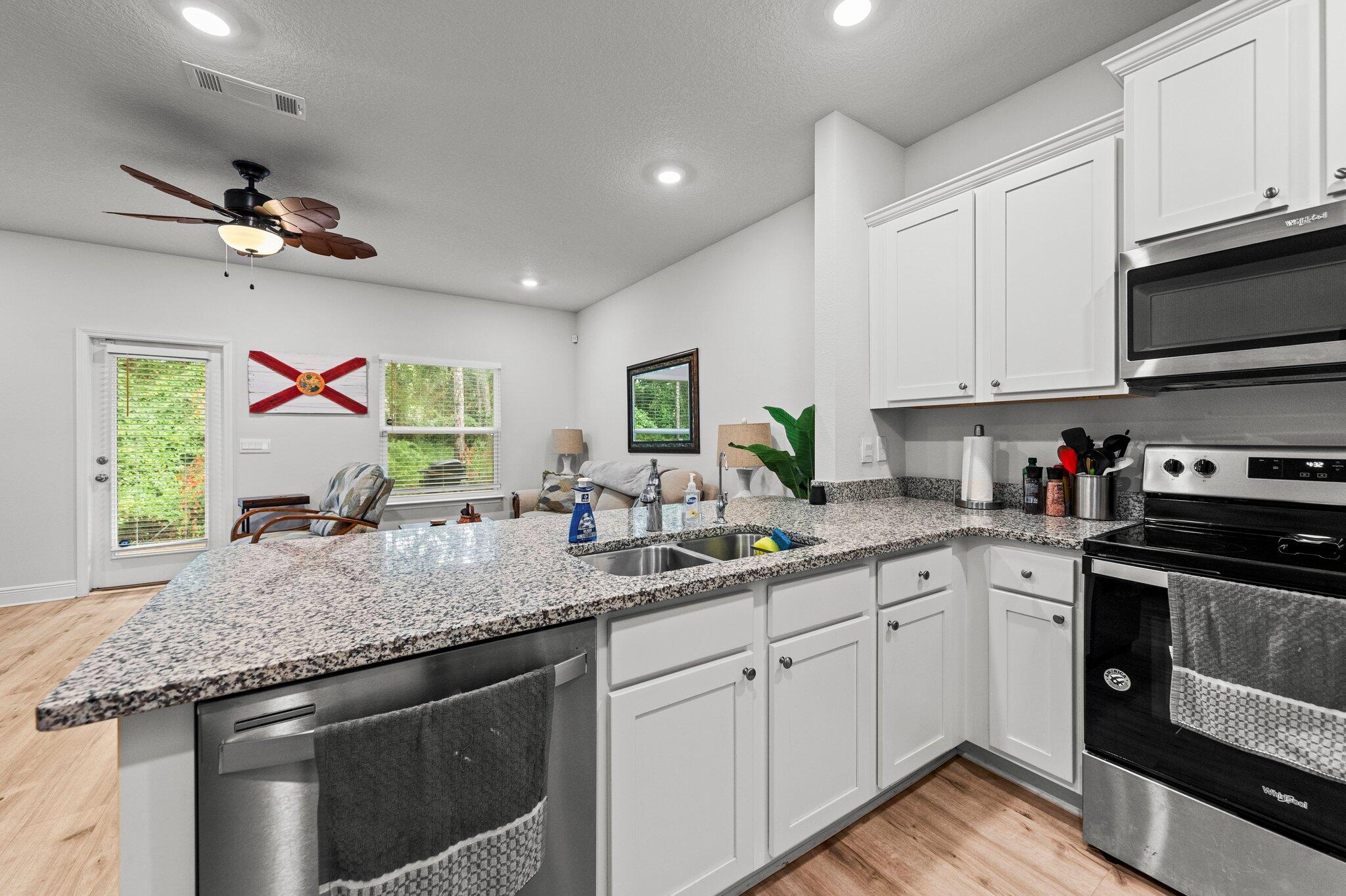 8 Sandy Cv Way Miramar Beach, FL 32550 - Photo 6 of 50 a kitchen with stainless steel appliances granite countertop a sink dishwasher a stove and a refrigerator with wooden floor