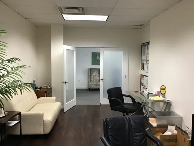 a view of a hallway with furniture and a livingroom view