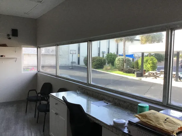 a living room with dining table chairs and wooden floor