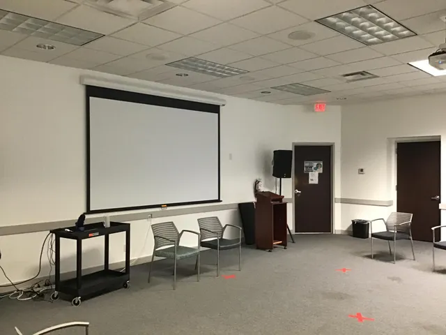 a living room with furniture and a mirror