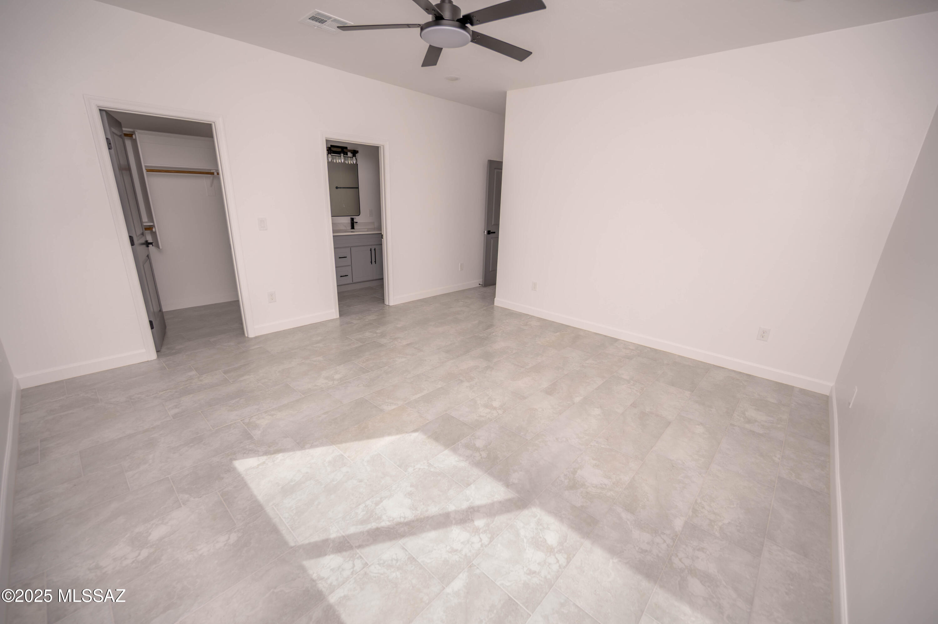 1781 Elder Court Rio Rico, AZ 85648 - Photo 17 of 50 an empty room with a ceiling fan and carpet