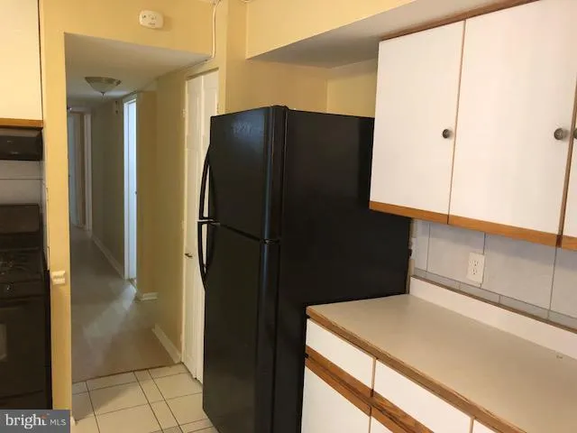 a kitchen with a refrigerator and cabinets