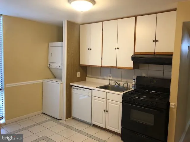 a kitchen with a sink and a stove top oven