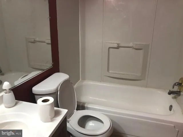 a bathroom with a sink a toilet and bathtub