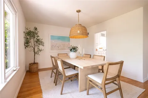 a view of a dining room with a table and chairs