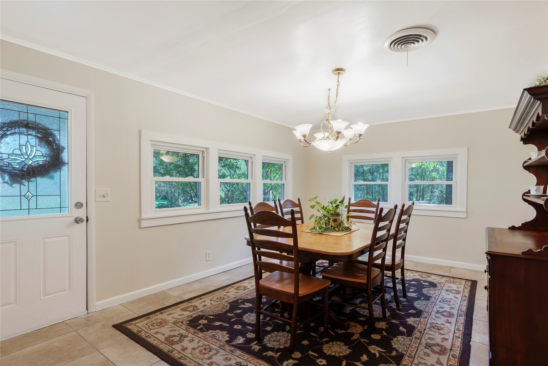 15552 Schank Road Conroe, TX 77306 - Photo 19 of 50 a dining room with furniture a chandelier and window