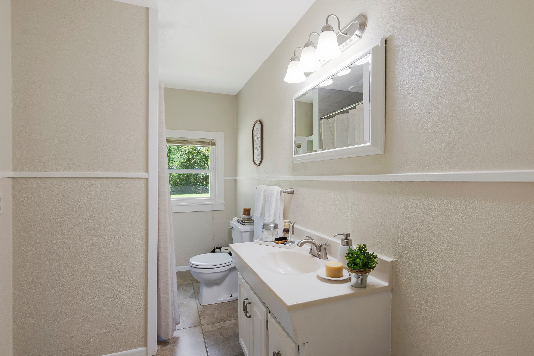 15552 Schank Road Conroe, TX 77306 - Photo 25 of 50 a bathroom with a sink mirror and toilet