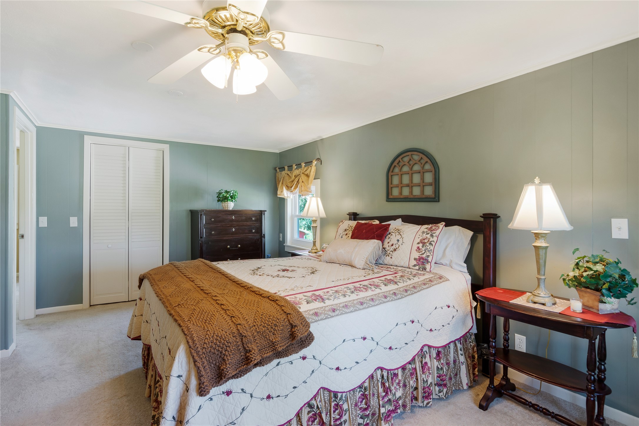 15552 Schank Road Conroe, TX 77306 - Photo 27 of 50 a bedroom with a bed and a chandelier