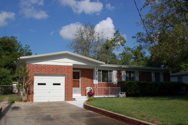 1920 Ector Road Jacksonville, FL 32211 - Photo 2 of 23 a front view of a house with a garden and trees