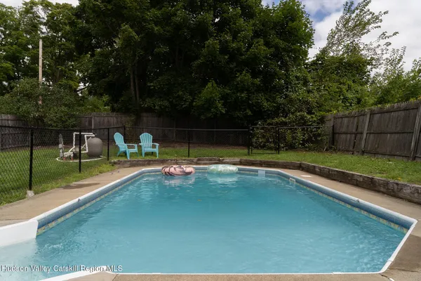 a view of swimming pool with seating space