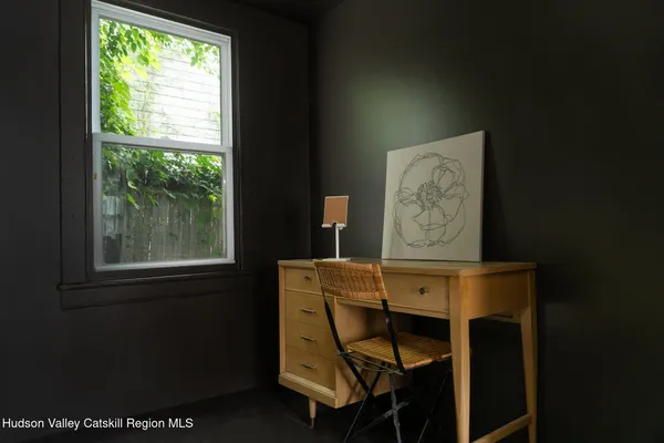 a view of a dining room with furniture and a window