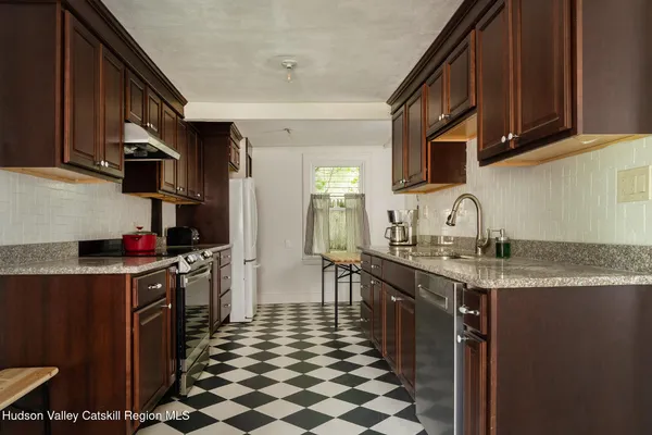 a kitchen with a sink stove and cabinets